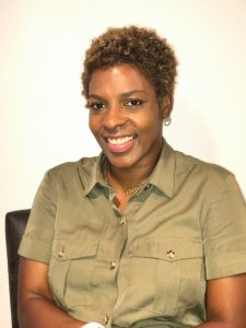 Woman with short hair and beige blouse