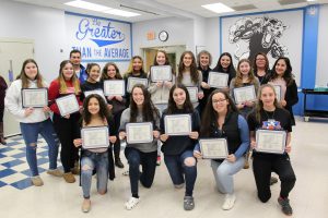 The Monticello Girls soccer team poses together with their Scholar Athlete certificates 