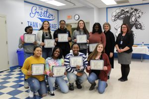 The Monticello volleyball team poses with their Scholar Athlete certificates during the Board Award ceremony 