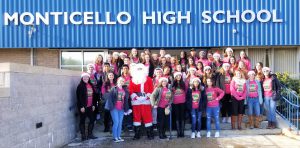 students pose with Santa outside of high school 