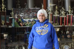 Urvashi Gupta stands before a trophy case