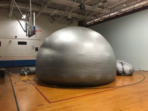 the starlab, a silver dome-like structure inside of the Emma C. Chase gymnasium 