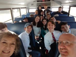 a group of students sitting on a bus on the way up to albany