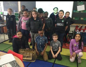 students who won the lunchroom award sit on their classroom rug