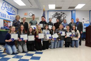 Ski teams pose with their awards