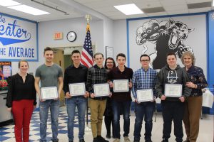 The Boys Alpine and Cross Country Ski team pose holding their scholar athlete certificates 