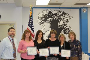 The Board Award recipients from Emma C. Chase Elementary School stand holding their Board Award certificates 