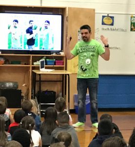 Author Daniel Miller speaks to students at the Emma C. Chase Elementary School 