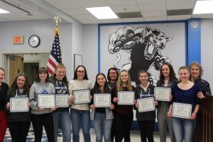 The girls alpine and cross country ski team holds their Scholar Athlete certificate during the Board Awards ceremony 