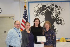 Megan Murray holds her Board Award certificate during the Board Awards cerermony 