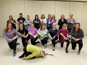 monticello educators do yoga poses during a training 