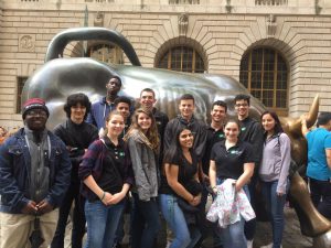 academy of finance students pose in front of the New York City bull statue 