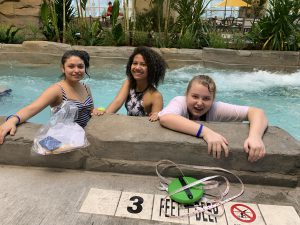 two students stand in the lazy river 