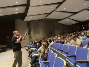 Speaker Michael Melasky addresses students in the Monticello High School auditorium 