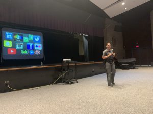 Trooper Suarez stands in front of an audience of Monticello students 