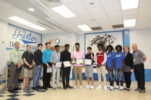 the boys track team holding their title 