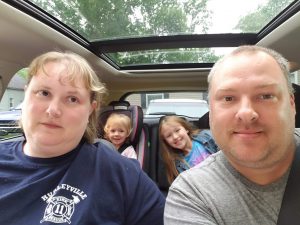 a photo of Charles Payne and his family in a car 