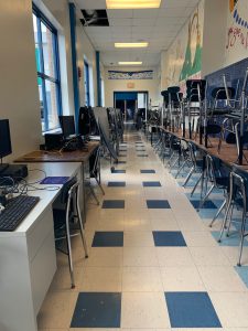 a hallway stacked with chairs 