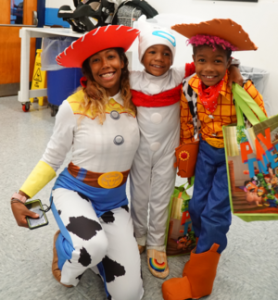 a family in Halloween costumes smile 