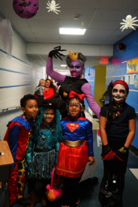 a group of children in costumes smiling