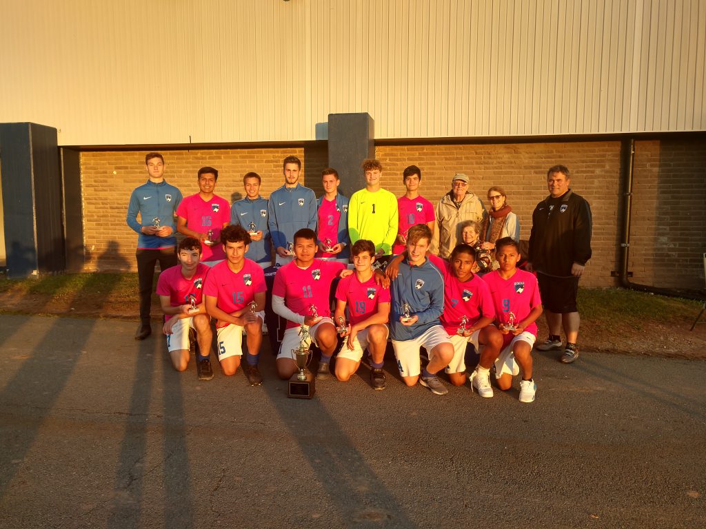 monticello boys soccer team poses after winning championship 