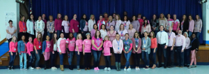 a group of staff all wearing pink shirts 