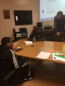 academy of finance students sit at a table 