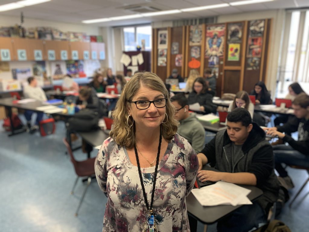 Karen Collura smiles in her classroom 