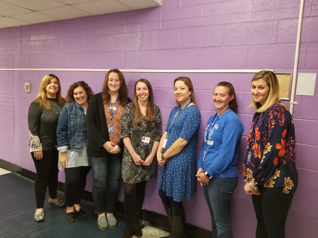 the kindergarten teachers at Cooke Elementary School are standing in a hallway and smiling 