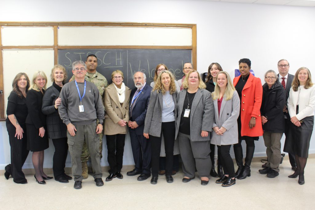 a group of representatives from agencies involved in the St John Street School Community Hub pose 