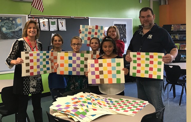 students stand with placemats