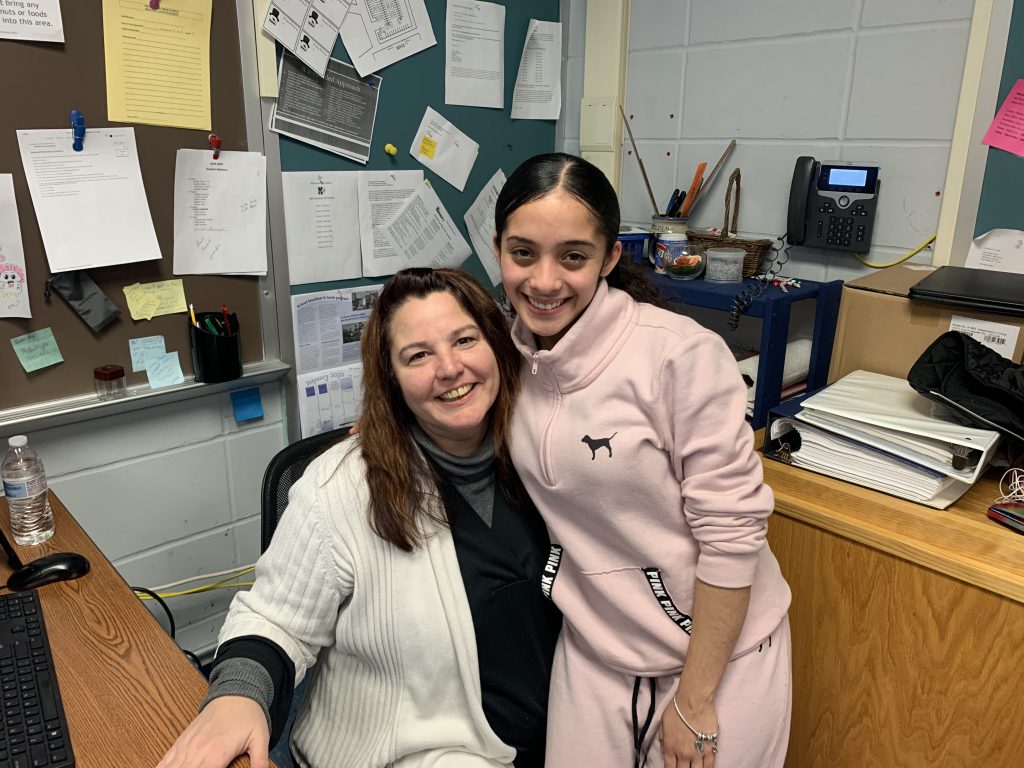 Mary Ellen Hurley smiles with a student 