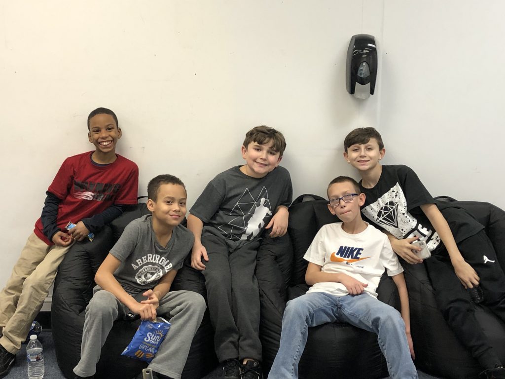 a group of boys are sitting on a couch at the HUB