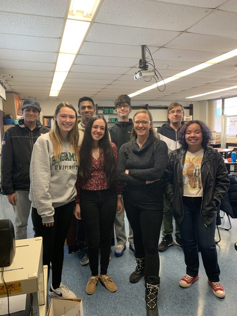 Teacher Kelly Keesler poses with students 