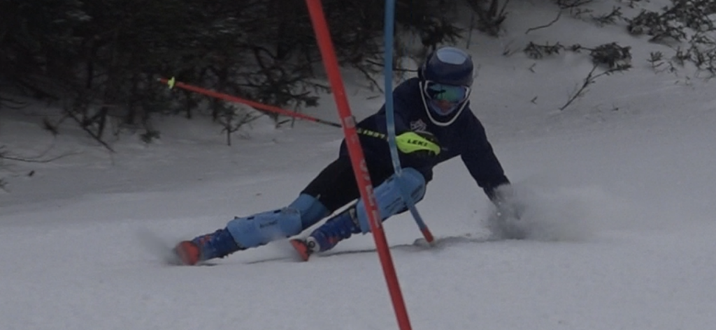 Shane Bittinger is skiing down a slope 