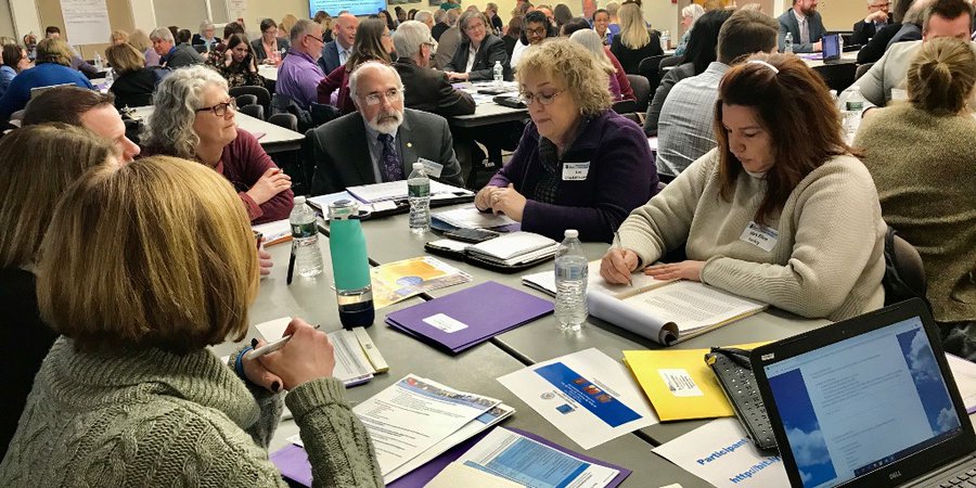 A group of Monticello educators are seated at a table talking