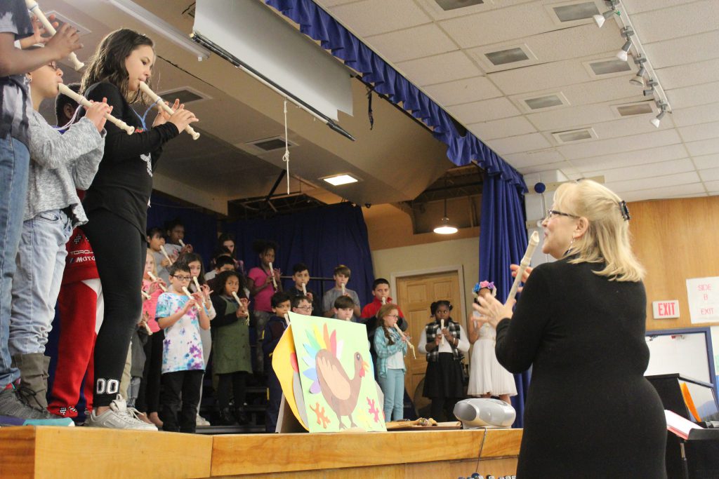 Joyce Wells is leading a group of young students playing recorder