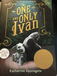 A green book cover with a gorilla and a baby elephant on it and the words The One and Only Ivan in gold