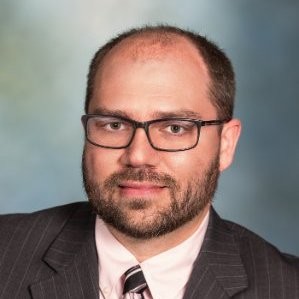 headshot of Dr. Matthew Evans on a gray background 