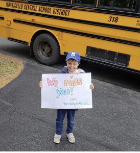 a student is holding up a sign 