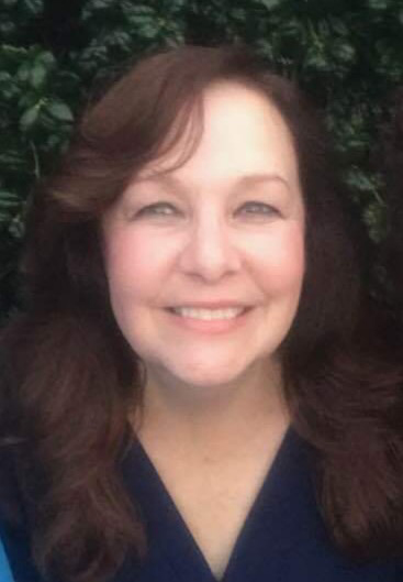 A woman with brown hair smiles