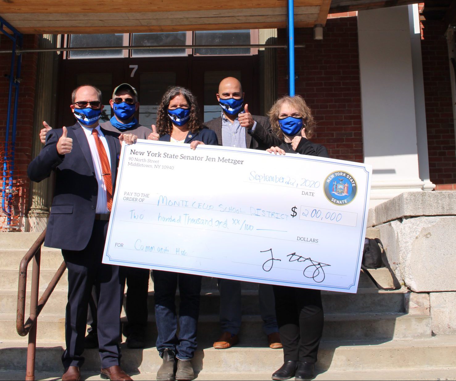 Monticello Superintendent of Schools Dr. Matthew Evans, Hub Coordinator Marty Colavito, Senator Jen Metzger, Village of Monticello Mayor George Nikolados and Board of Education President Lori Orestano-James pose outside of the Hub after the press conference held on Sept. 22