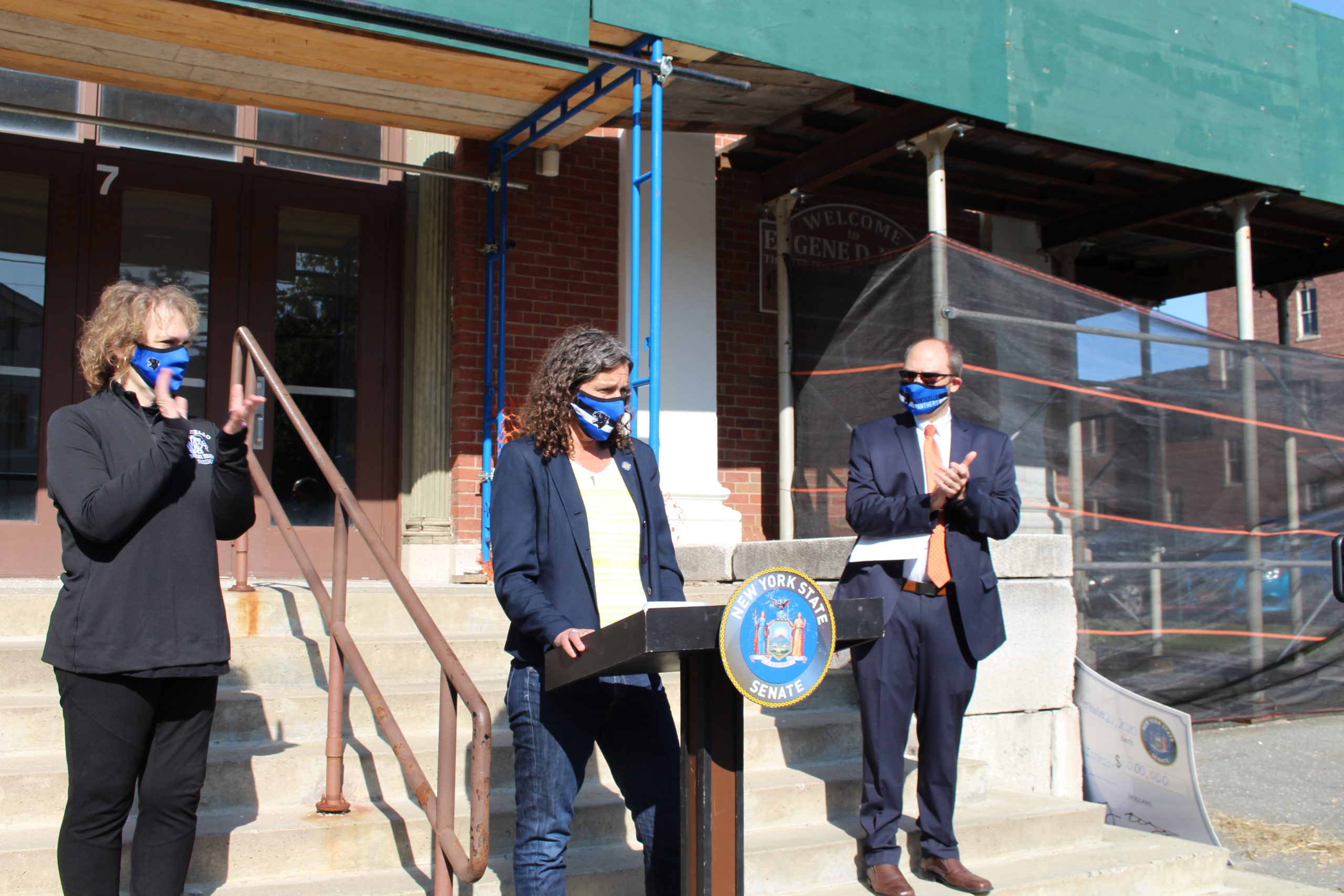 Board President Lori Orestano-James and Superintendent of Schools Dr. Matthew Evans applaud as Senator Jen Metzger speaks on Sept. 22