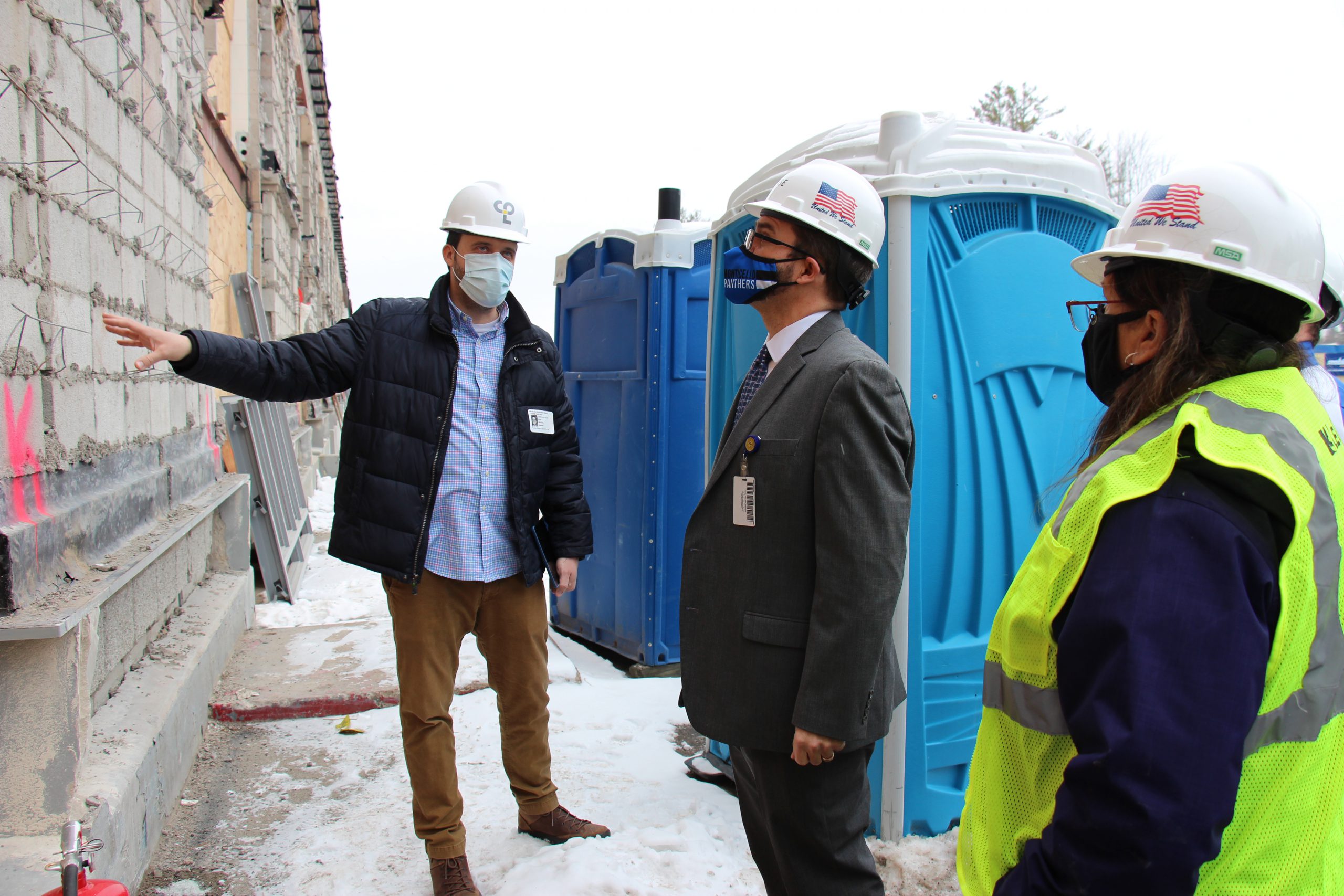 Superintendent Matt Evans and Business Official Lisa Failla are standing by the high school and looking up at the construction project 