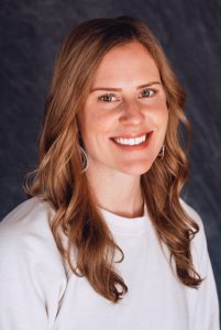 headshot of candace rivela. She is wearing a white shirt and smiling 