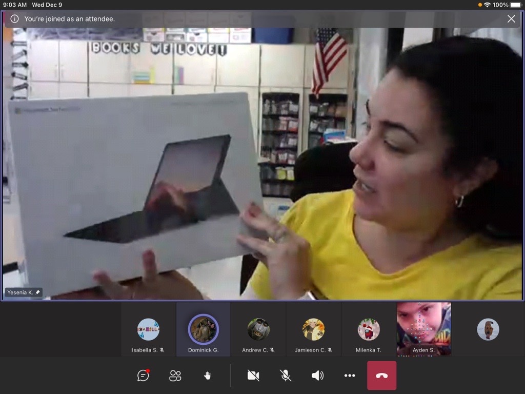 screen shot of a virtual lesson. Ms. Kreeger is holding up the new tablet to the webcam and her students are watching 