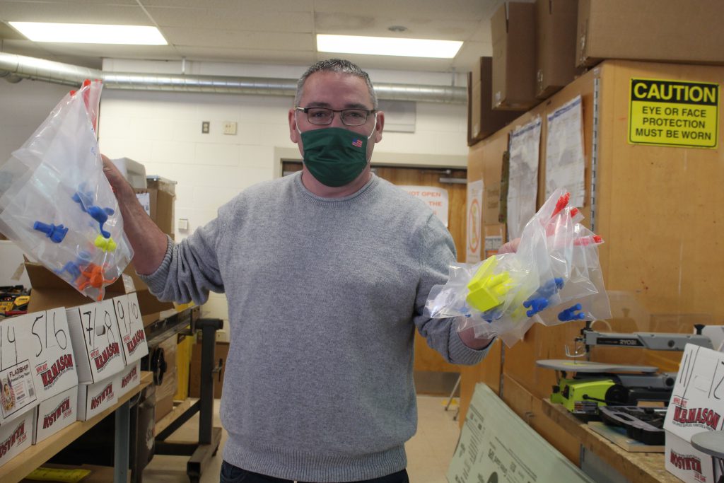 Mr. Oefelein is holding up two bags of projects 