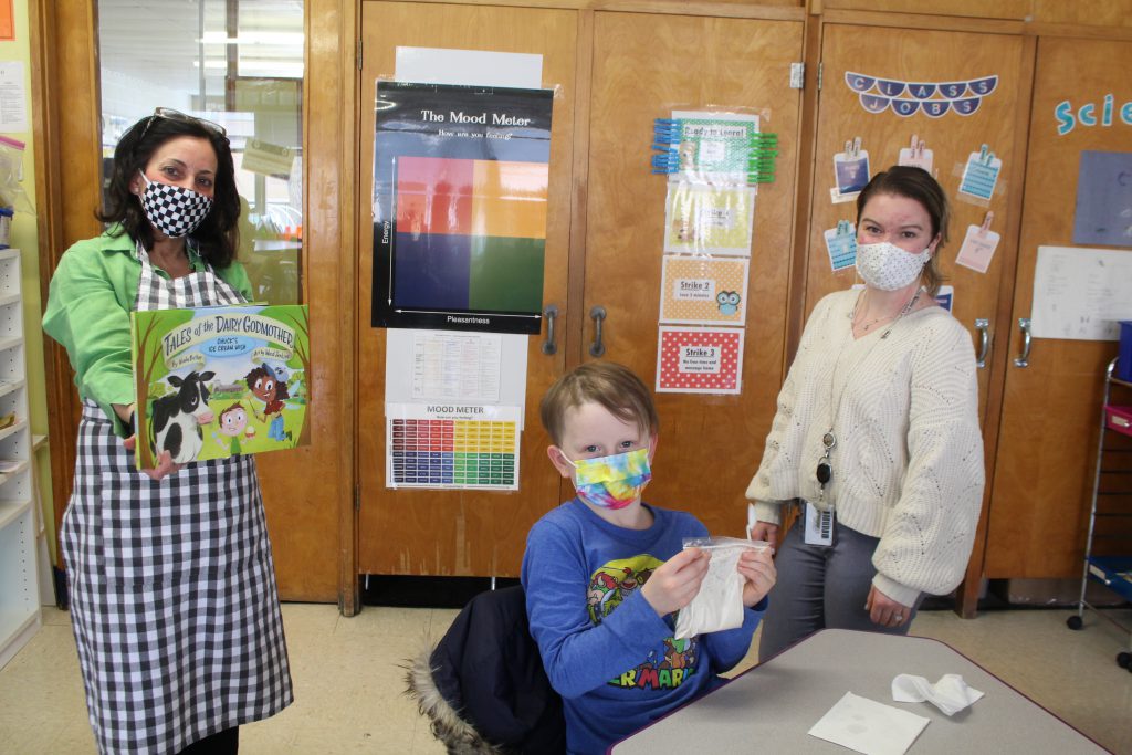 Jane Sorensen, Ms. Kilcoin and a student are sitting at a table 