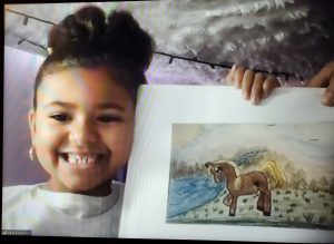 screen shot of student holding up a hand drawn picture of a horse during a virtual reading