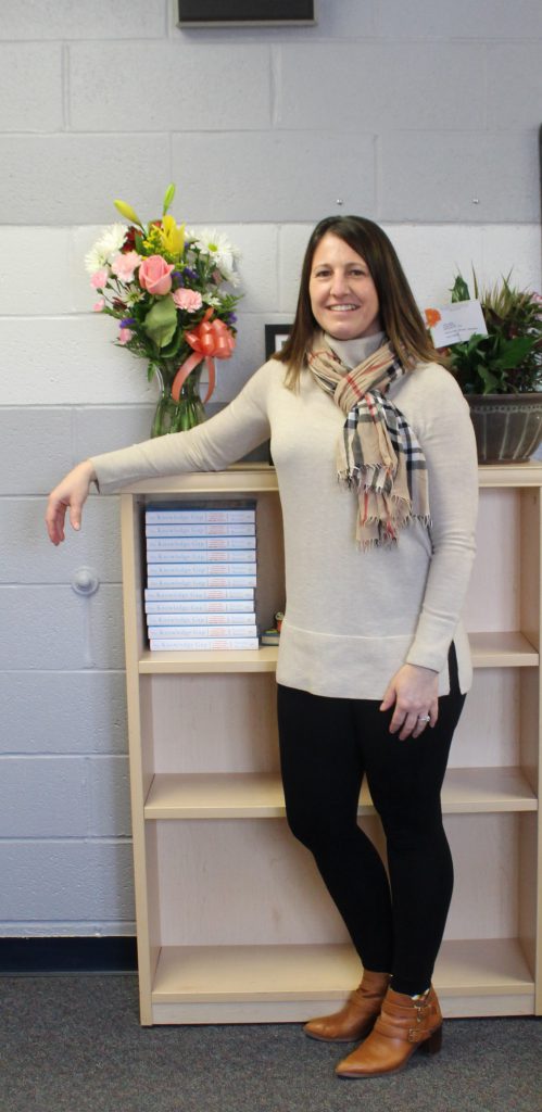 Ginny Gallet is standing in her office and smiling 